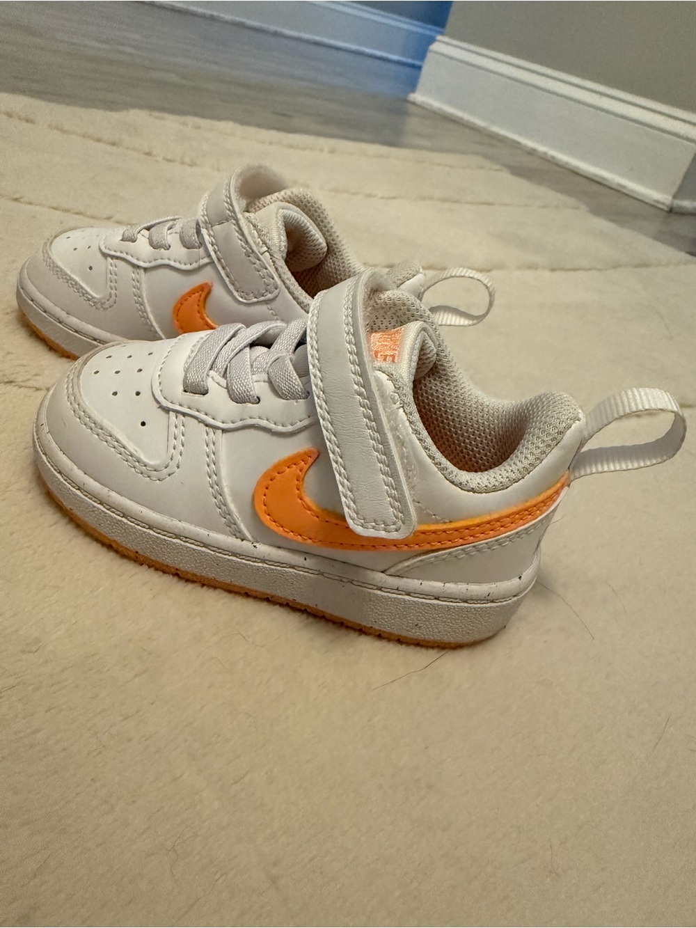 Nike Kids White Sneakers with Orange Swoosh Accent